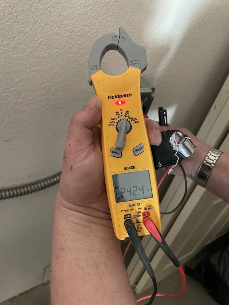 Voltage testing with clamp meter during Electrical Installation Services in Bemiss